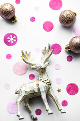 Christmas festive background with beautiful deer, golden balls and confetti