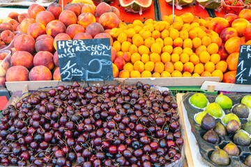 Naklejka na ściany i meble Cherries, plums and other fruits for sale a market