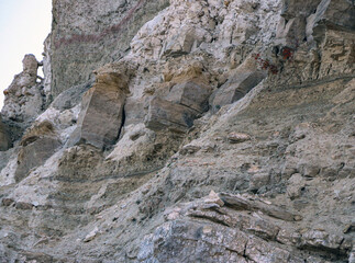 sandy-gypsum cut of the earth in quarry for the extraction of gypsum. Mountain textures of...
