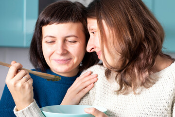 LGBT lesbian couple having fun in the kitchen.
