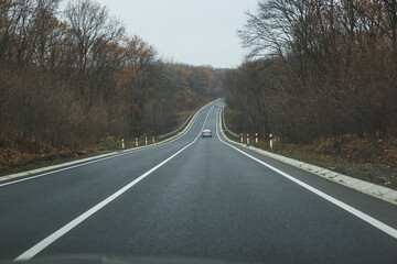Fototapeta premium Autumn road landscape. View from the car.