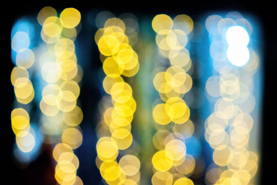 yellow blurry Christmas lights on the streets. holiday night background with bokeh effect.
