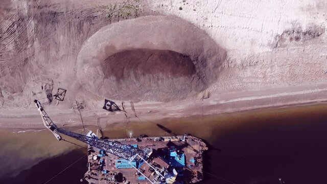 A dredger unloads sand onto the&nbsp;shore&nbsp;from a dump scow