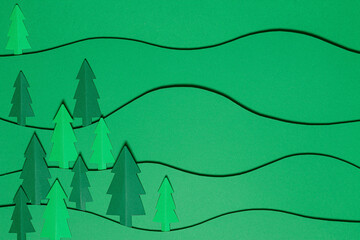 Christmas tree paper cutting design papercraft card. Paper cut Christmas trees. Creative design of christmas background with paper fir tree. The art picture with forest, christmas fir. paper craft.