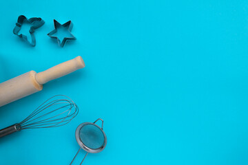Different baking tools on blue background, top view. Baking and cooking concept