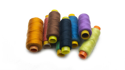 A various colors of sewing thread roll on an isolated white background.