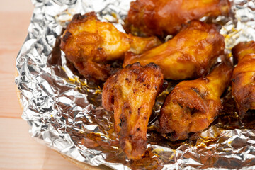 Shot of drumette chicken wing stick grilled on aluminium foil