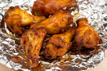 Shot of drumette chicken wing stick grilled on aluminium foil