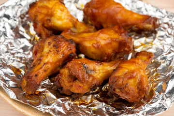 Shot of drumette chicken wing stick grilled on aluminium foil