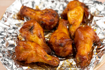 Shot of drumette chicken wing stick grilled on aluminium foil