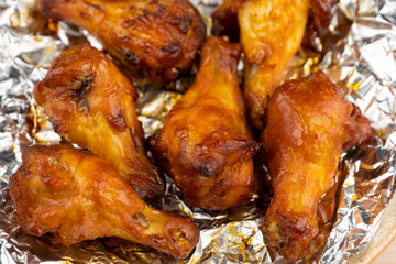 Shot of drumette chicken wing stick grilled on aluminium foil