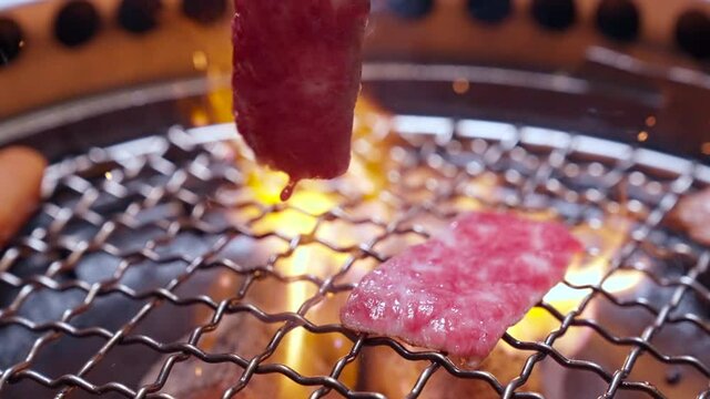 4K Handheld Charcoal grilled Kobe Wagyu beef sliced Yakiniku Slow motion