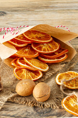 Christmas composition. Arrangement of dry Oranges, cinnamon sticks and walnuts on wooden background. Rustic, Holiday spices ingredients
