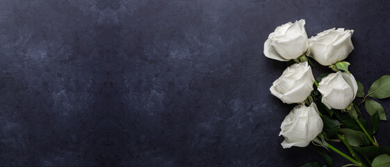 Horizontal banner with white rose flowers bouquet on black stone background. Top view copy space - 396949950