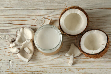 Fresh coconut and coconut milk on wooden background