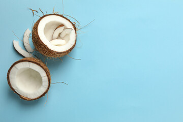Fresh tasty coconut on blue background, top view