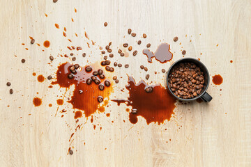 Cup and coffee stains on wooden background