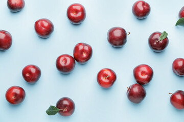 Fresh ripe plums on  color background