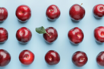 Fresh ripe plums on  color background