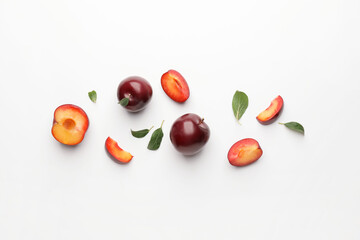 Fresh ripe plums on  white background