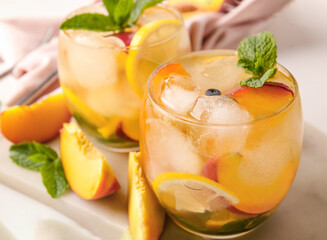 Peach cocktail in glasses on light background