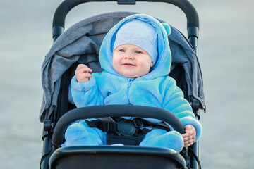 Cute funny baby in stroller outdoors