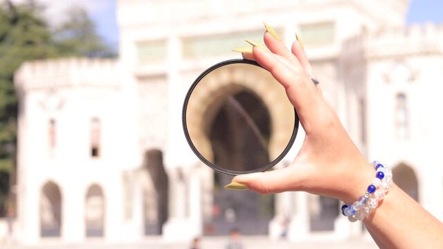 Female hand holding a large diameter photo filter