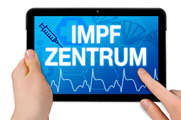 Tablet with medical touchscreen and the german word for covid-19 vaccination center or centre - impfzentrum isolated
