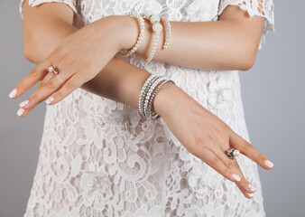 Beauty, jewelry and luxury concept - close up of beautiful. Woman bracelet and rings.