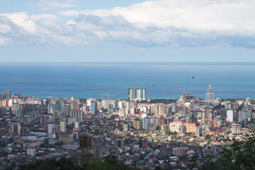 Obraz premium Evening landscape. Top view of the Black sea, the sea port of Batumi against the background of white clouds. Space for text, design cards, calendars, or posters. Georgia.
