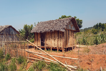 Fototapeta na wymiar Traditional wooden african malagasy hut with roof from straw, typical village in central Madagascar.