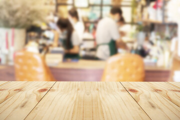 Empty dark wooden table in cafe of abstract blurred background