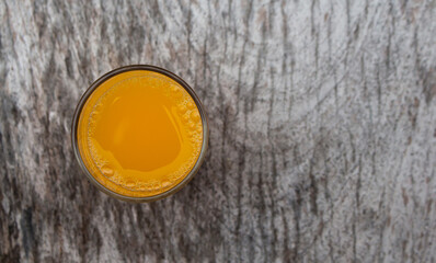 Glass of fresh orange juice from top view