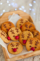 Rudolph christmas cookies with chocolate and red dragee, selective focus