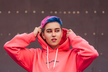 Portrait of a young girl with short colorful hair and nose piercing