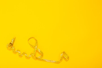 International Women's Day 8 March. World Mother's Day 8 May. Centimeter tape twisted in the shape of the number 8 on yellow background. Greeting card with copy space for text. Hello spring. Close-up