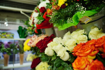 Bouquets of various flowers on counter. Fresh beautiful flowers in florist shop.