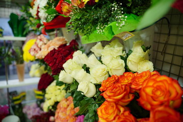 Bouquets of various flowers on counter. Fresh beautiful flowers in florist shop.