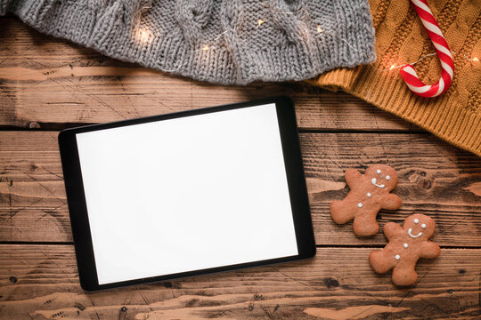 Christmas mockup with tablet, gingerbread men, festive and christmas cane, top view
