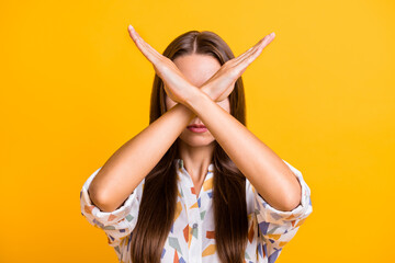 Photo of young woman cover face crossed hands stop sign denial negative no ban isolated over yellow...