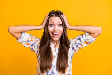 Photo of young girl happy smile amazed shocked wow surprised sale discount news hands touch head isolated over yellow color background