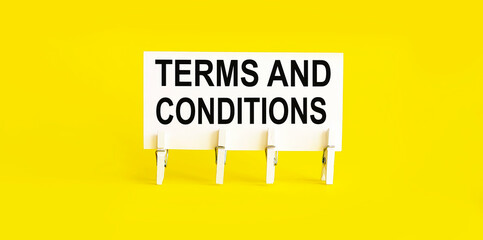 text TERMS AND CONDITIONS on white short note paper on yellow background