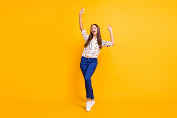 Full length photo portrait of fit woman dancing with closed eyes isolated on vivid yellow colored...