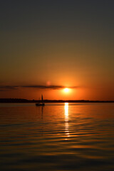 Naklejka na ściany i meble beautiful and sunny sunset on the lake