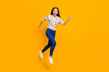Fototapeta na wymiar Photo portrait full body view of ecstatic running woman screaming jumping up isolated on vivid yellow colored background