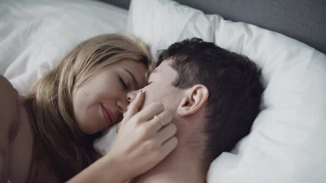 Young couple in underwear passionately kissing in morning after waking up. Intimacy moment. Love. sex, family, relations concept. Filmed on RED 4k.