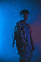 black afro american man with red and blue neon lights on his face posing and acting 