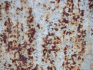 Rust.Old blue painted wall with rust spots.Textured rusty metal background. Rust stains through the cracked blue paint.