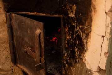 the ajar door of the Russian stove in the process of burning fuel, carbon monoxide escapes