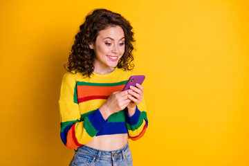 Photo of cute optimistic brunette hair young lady chatting telephone wear pullover isolated on bright yellow background